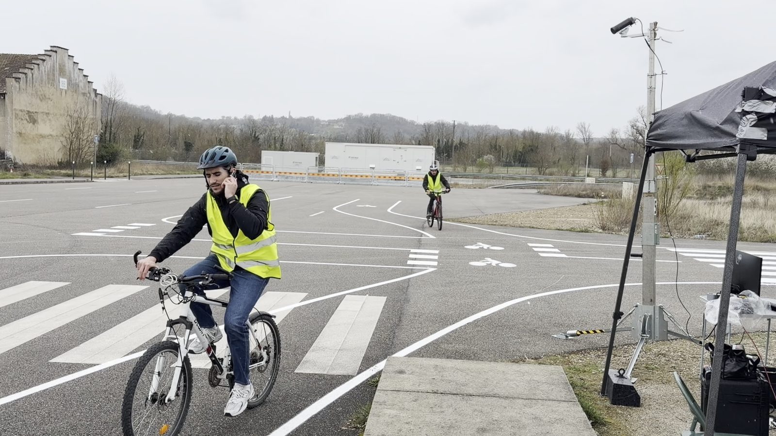 A test cyclist rides past the camera while using a mobile phone, one of the risky behaviours tested in the pilot